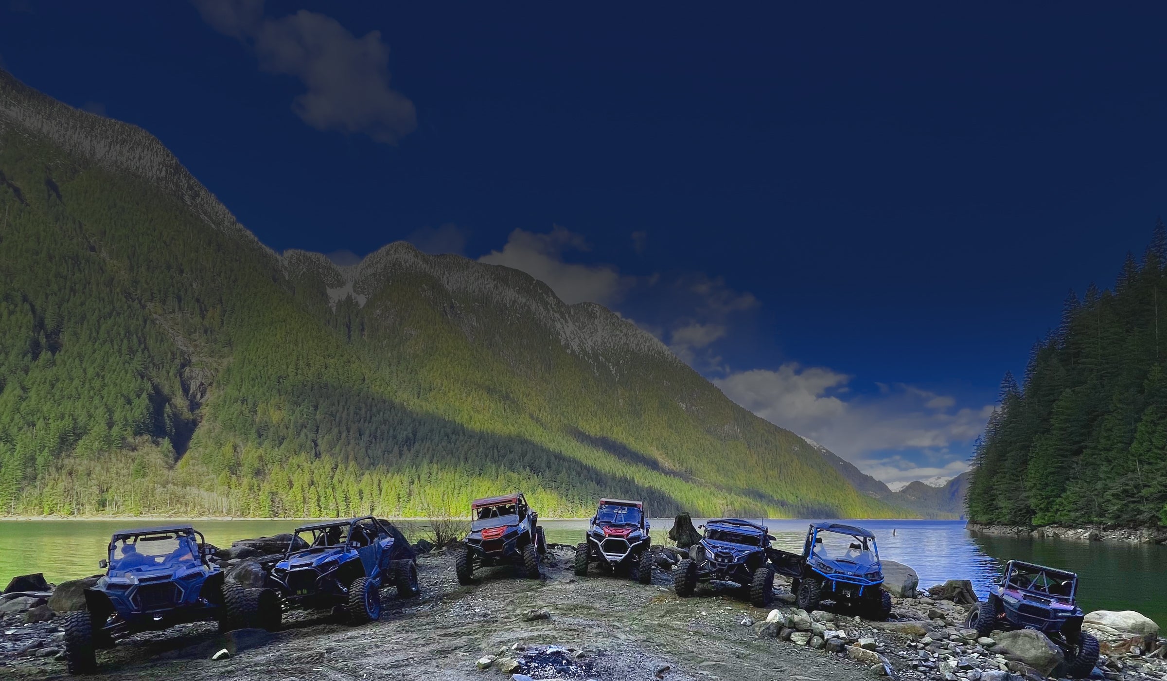 UTVs With Skid Plates Lined Up Next to Lake