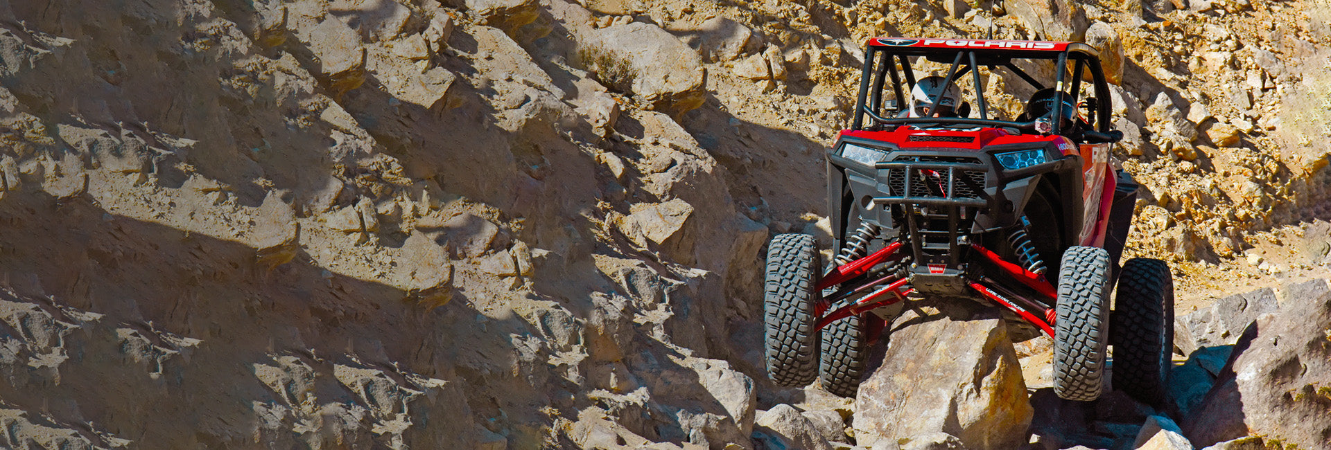 Skid Plate Protecting a UTV from a Boulder